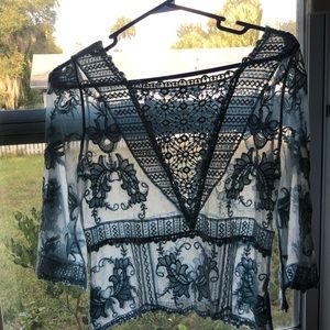 Baby blue crochet floral top with bell sleeves 100% polyester for easy care.